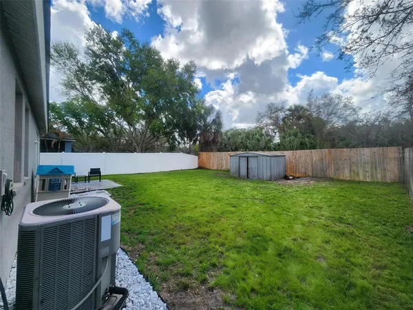 a backyard of a house with lots of green space