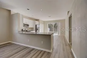 a kitchen with stainless steel appliances a refrigerator sink and microwave