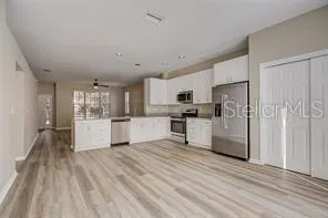 a kitchen with stainless steel appliances a refrigerator sink and cabinets
