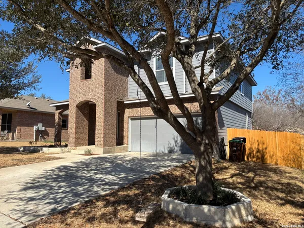a large tree in front of a house