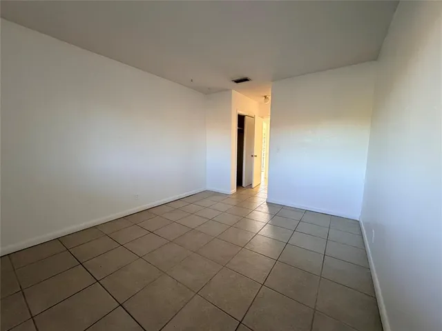 a view of an empty room and wooden floor