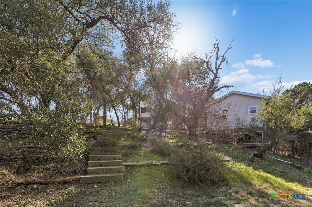 515 Valley Ridge Canyon Lake, TX 78133 - Photo 34 of 47 Steps leading to a lower terrace with a firepit.