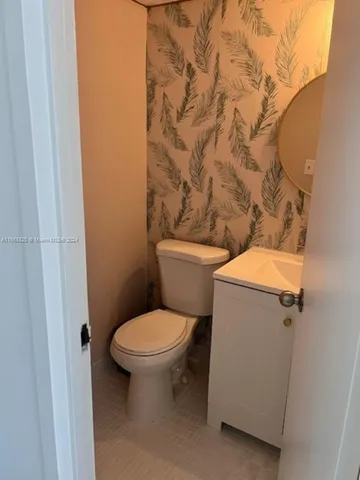 a white toilet sitting next to a white sink