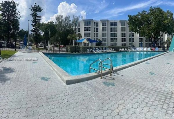 a swimming pool with outdoor seating and yard