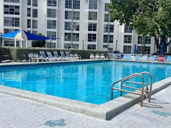 a view of a swimming pool with a lounge chairs