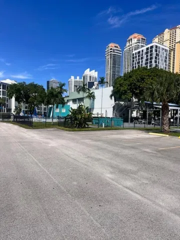 a front view of a building with trees