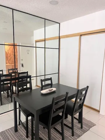 a view of a dining room with furniture and window