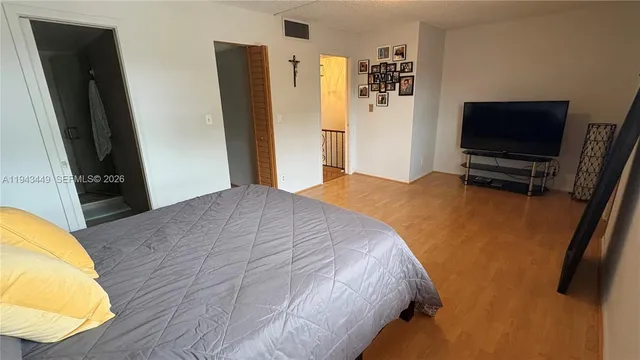 a bedroom with a bed and flat screen tv