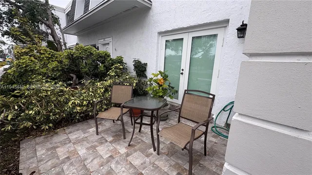 a view of a chairs and table in a backyard