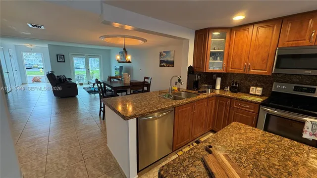 a kitchen with a sink stove and refrigerator