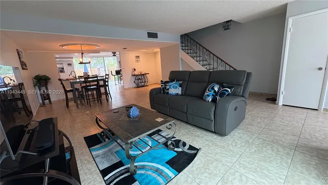 a living room with furniture rug and outdoor view