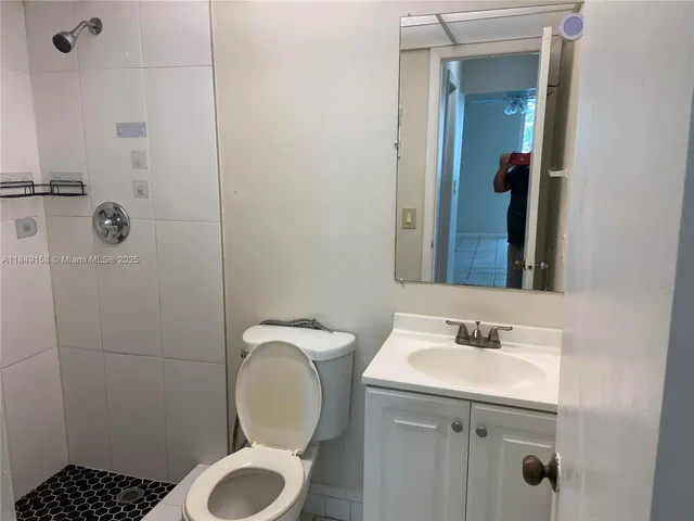 a bathroom with a sink toilet and shower