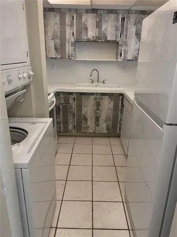 a kitchen with a sink a stove and cabinets
