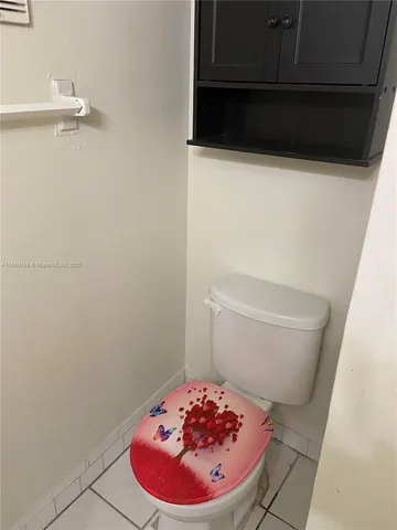 a bathroom with a toilet and a mirror