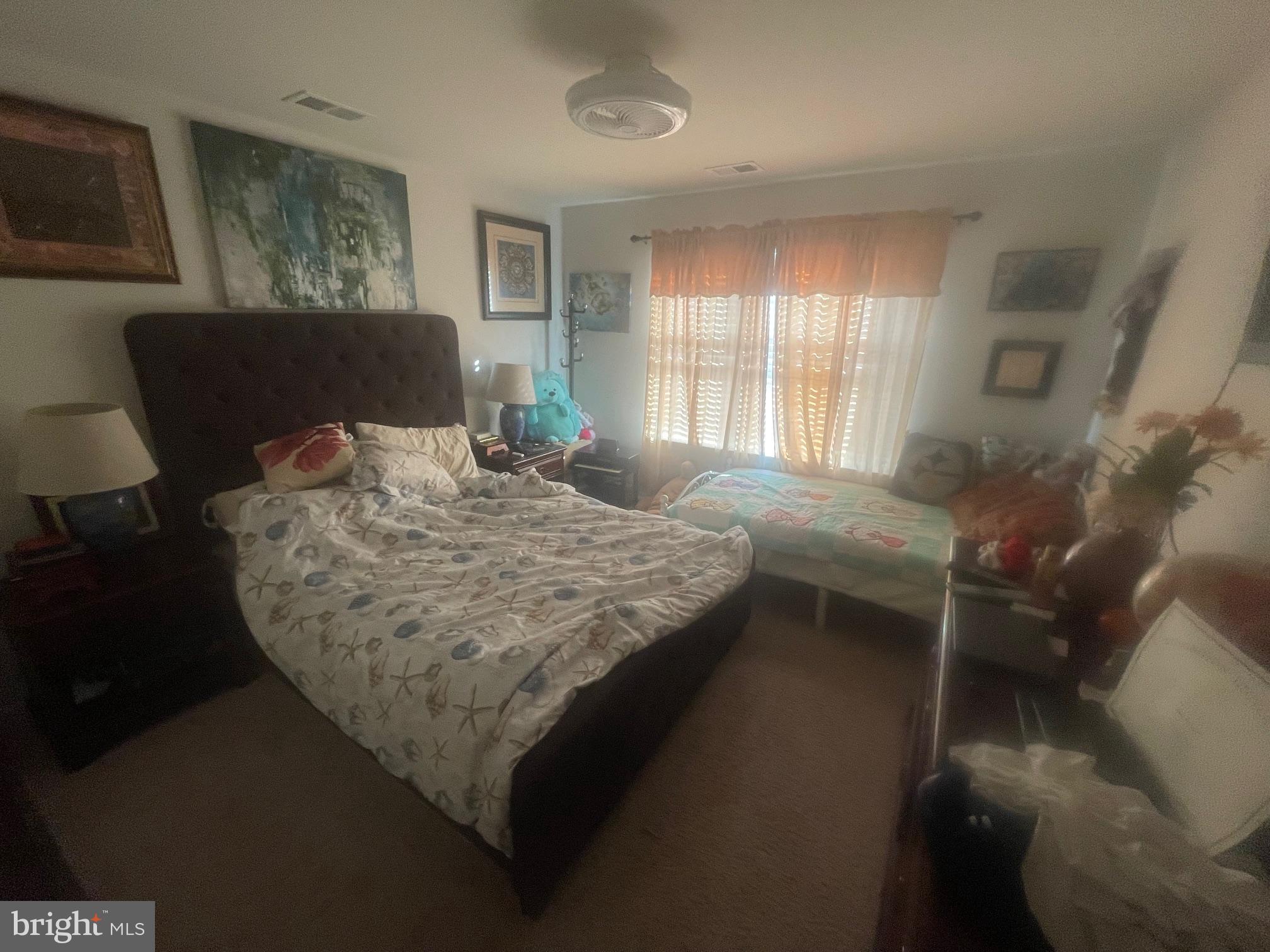 31715 Impetus Road Lewes, DE 19958 - Photo 7 of 12 a bed sitting in a bedroom next to a window