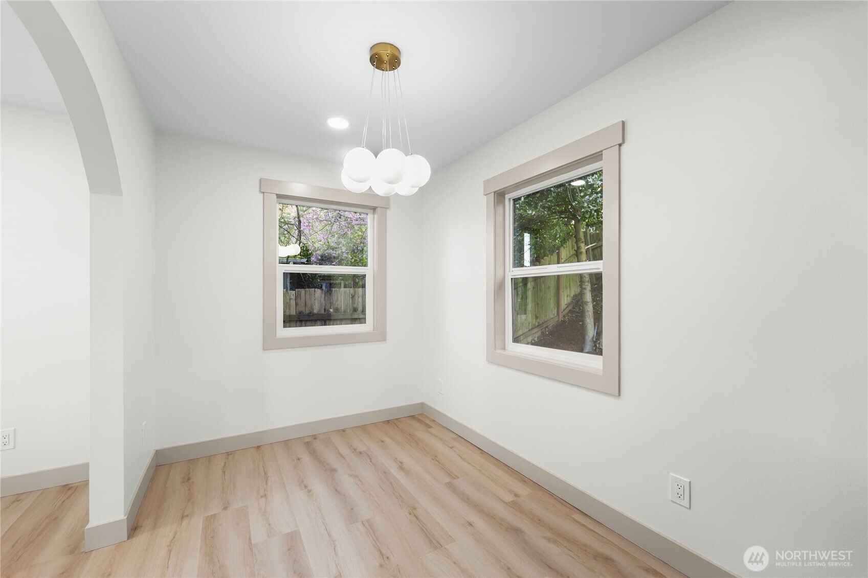 9825 32nd Avenue Southwest Seattle, WA 98126 - Photo 16 of 34 an empty room with wooden floor and windows