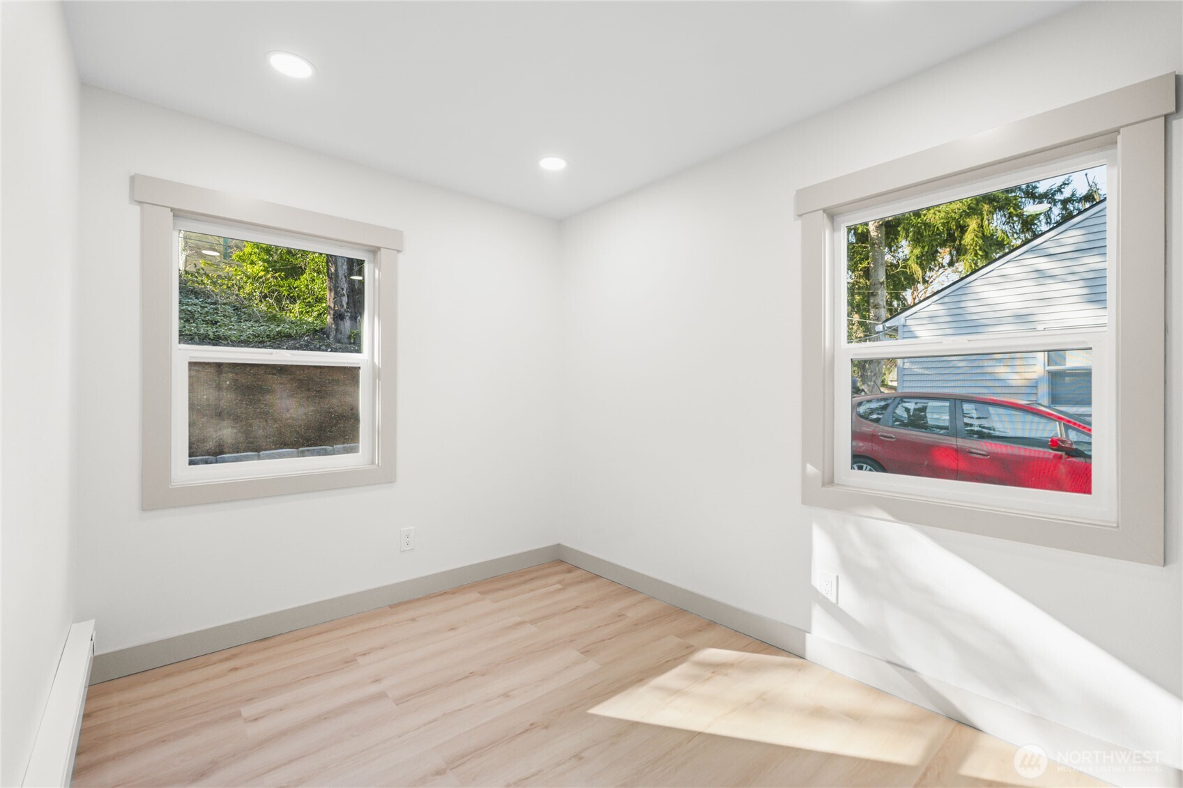 9825 32nd Avenue Southwest Seattle, WA 98126 - Photo 17 of 34 a view of an empty room with wooden floor and a window