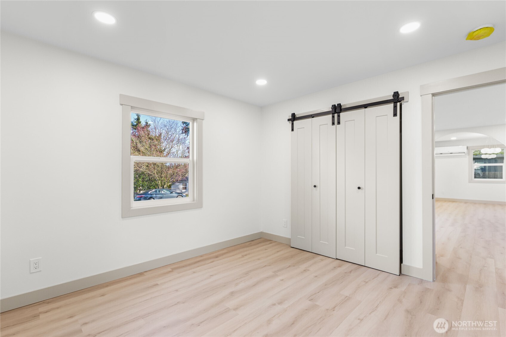 9825 32nd Avenue Southwest Seattle, WA 98126 - Photo 21 of 34 a view of an empty room with wooden floor and a window
