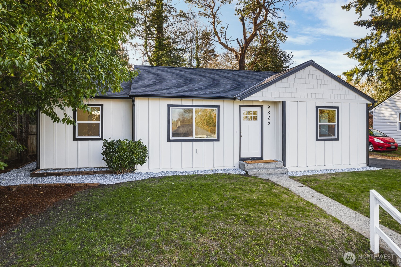 9825 32nd Avenue Southwest Seattle, WA 98126 - Photo 26 of 34 a front view of a house with a yard and garage