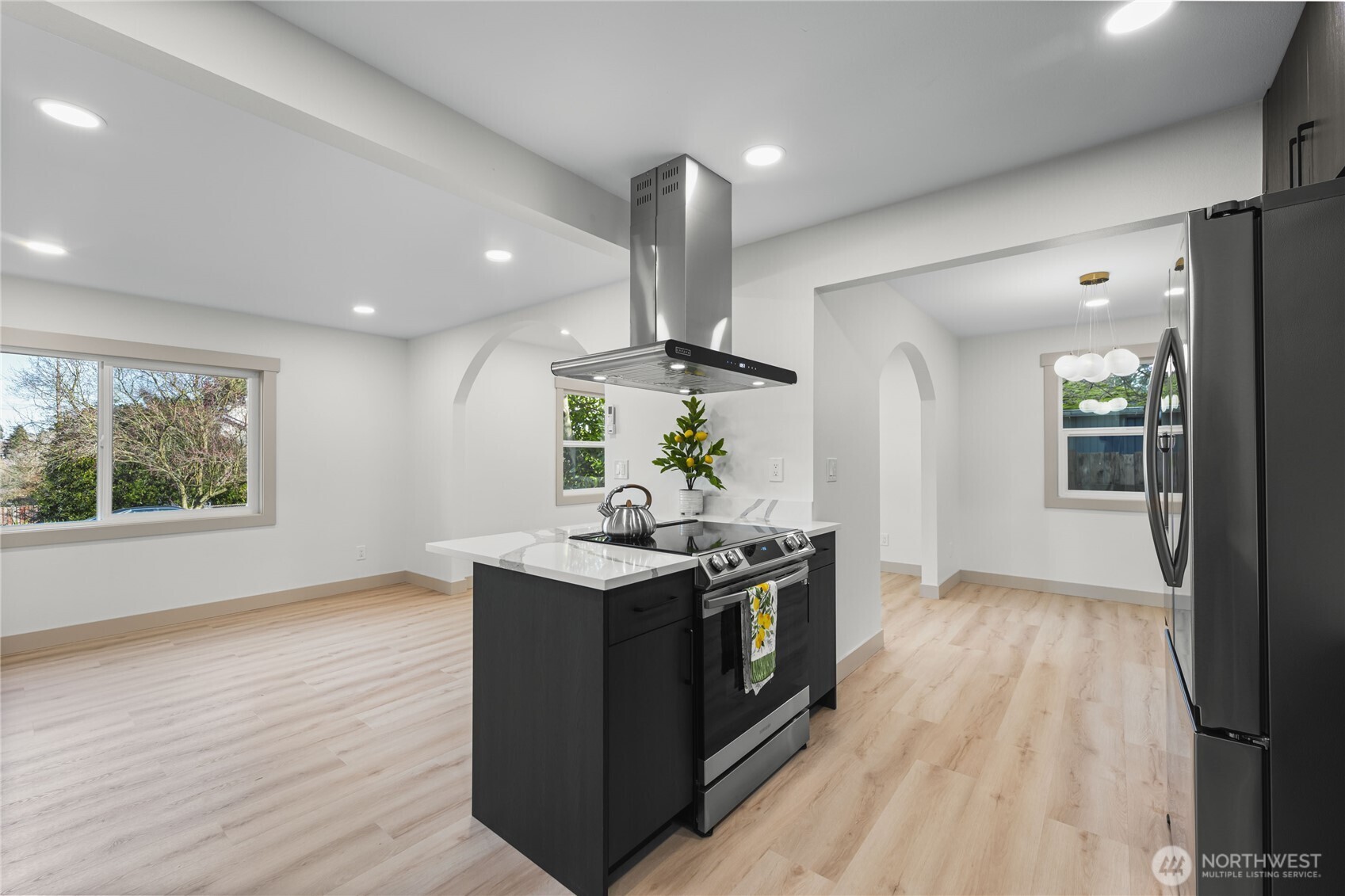 9825 32nd Avenue Southwest Seattle, WA 98126 - Photo 5 of 34 a kitchen with stainless steel appliances granite countertop a stove and a wooden floors