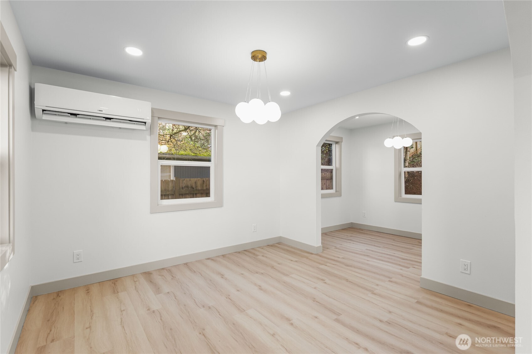 9825 32nd Avenue Southwest Seattle, WA 98126 - Photo 10 of 34 an empty room with wooden floor and windows