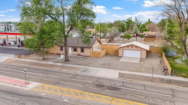a view of a house with a backyard and a garage