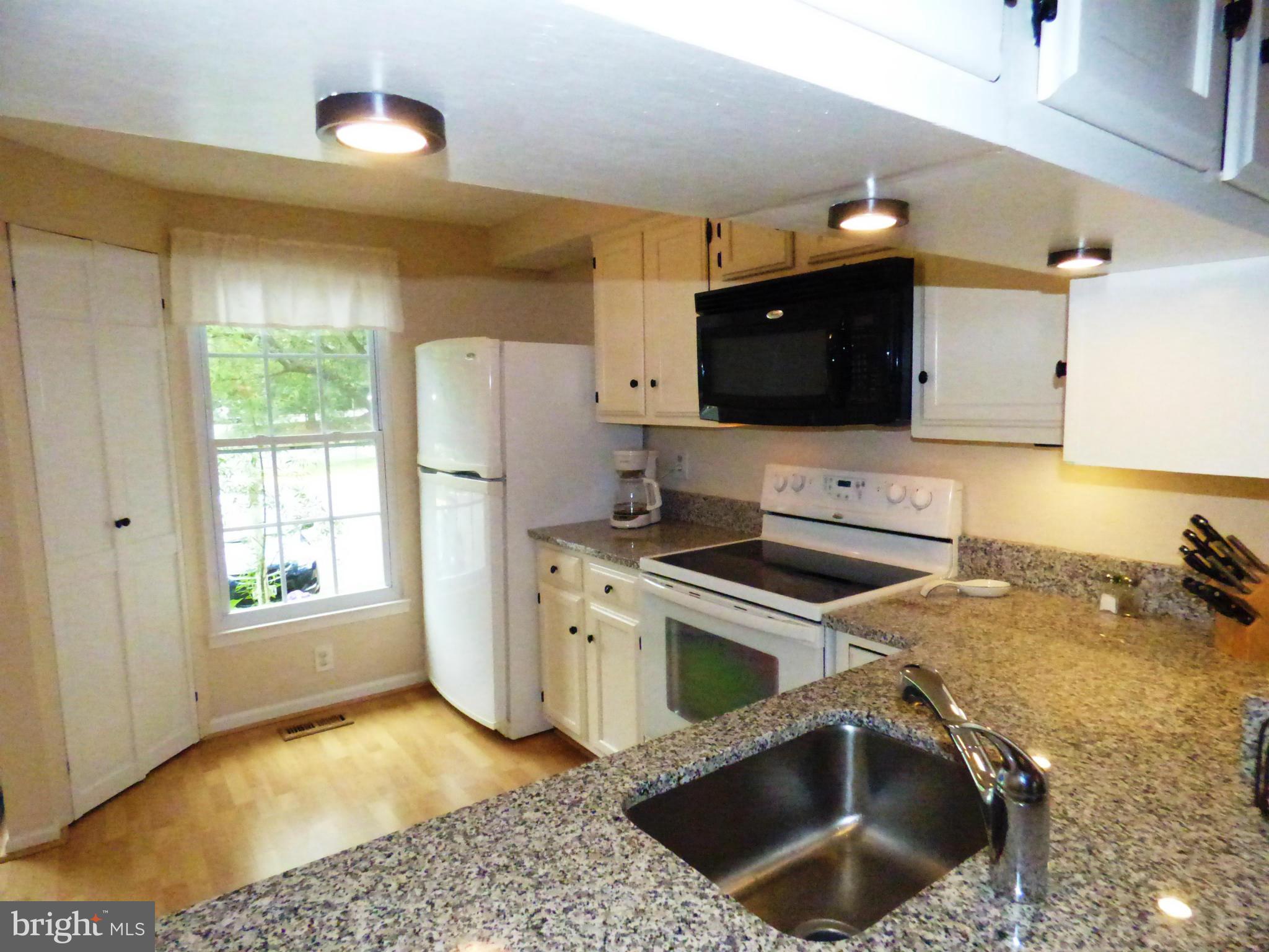 1634 Fieldthorn Drive Reston, VA 20194 - Photo 3 of 30 a kitchen with a stove a refrigerator and a stove top oven