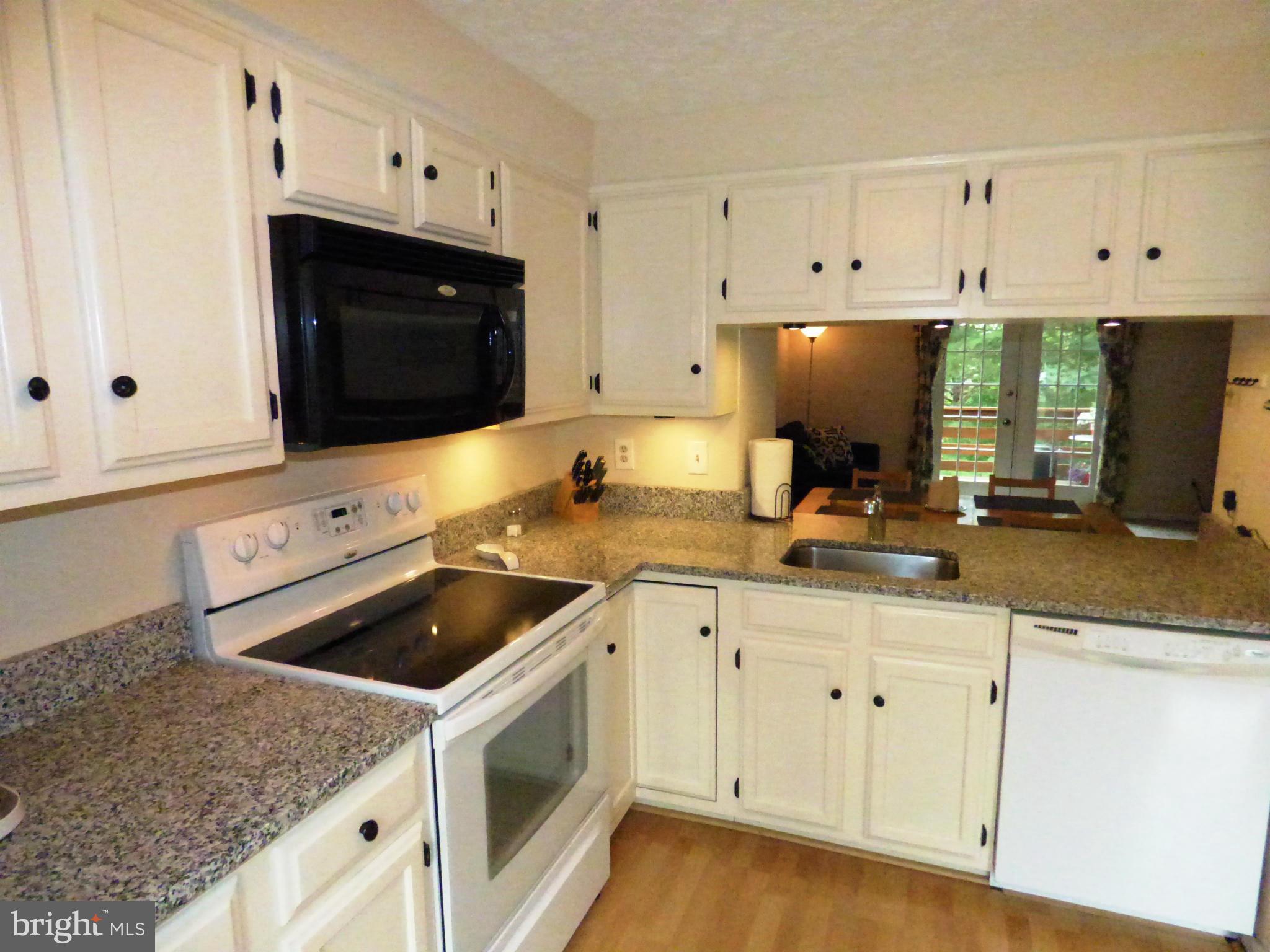 1634 Fieldthorn Drive Reston, VA 20194 - Photo 5 of 30 a kitchen with white cabinets and white appliances