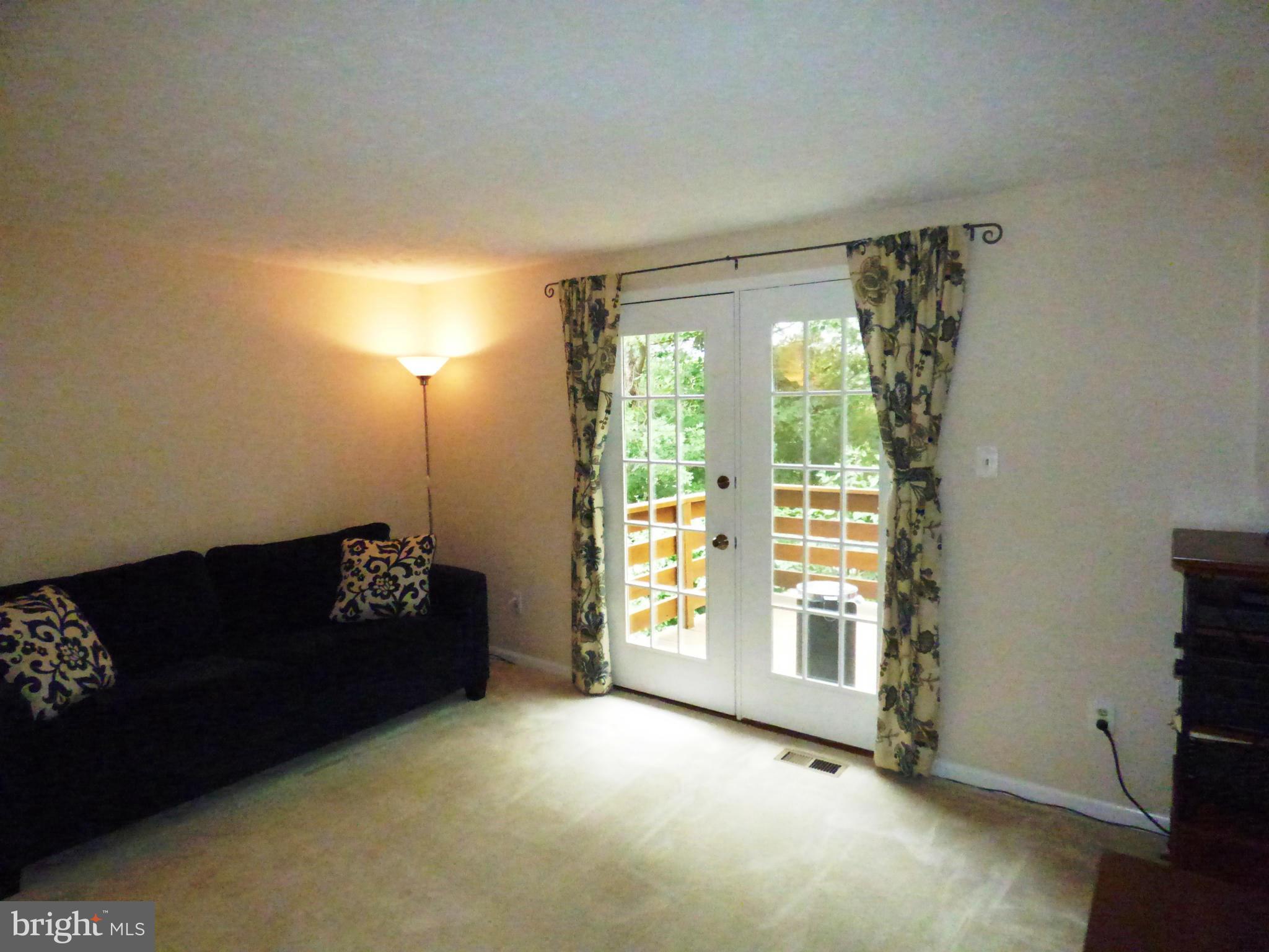 1634 Fieldthorn Drive Reston, VA 20194 - Photo 7 of 30 a living room with furniture and a floor to ceiling window