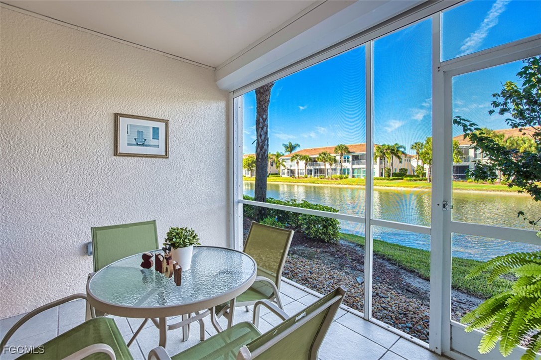 11611 Navarro Way, Unit 2002 Fort Myers, FL 33908 - Photo 1 of 45 a balcony with table and chairs