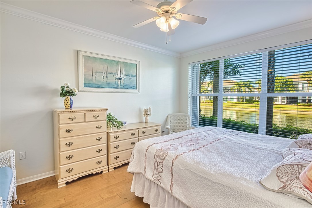 11611 Navarro Way, Unit 2002 Fort Myers, FL 33908 - Photo 20 of 45 a bedroom with a bed and a window