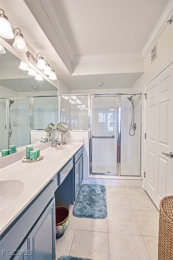 11611 Navarro Way, Unit 2002 Fort Myers, FL 33908 - Photo 23 of 45 a bathroom with a granite countertop sink a mirror and a shower