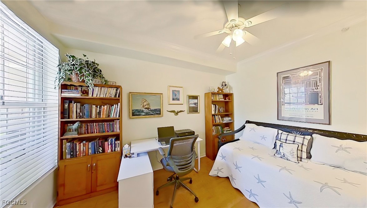 11611 Navarro Way, Unit 2002 Fort Myers, FL 33908 - Photo 28 of 45 a bedroom with furniture and a book shelf