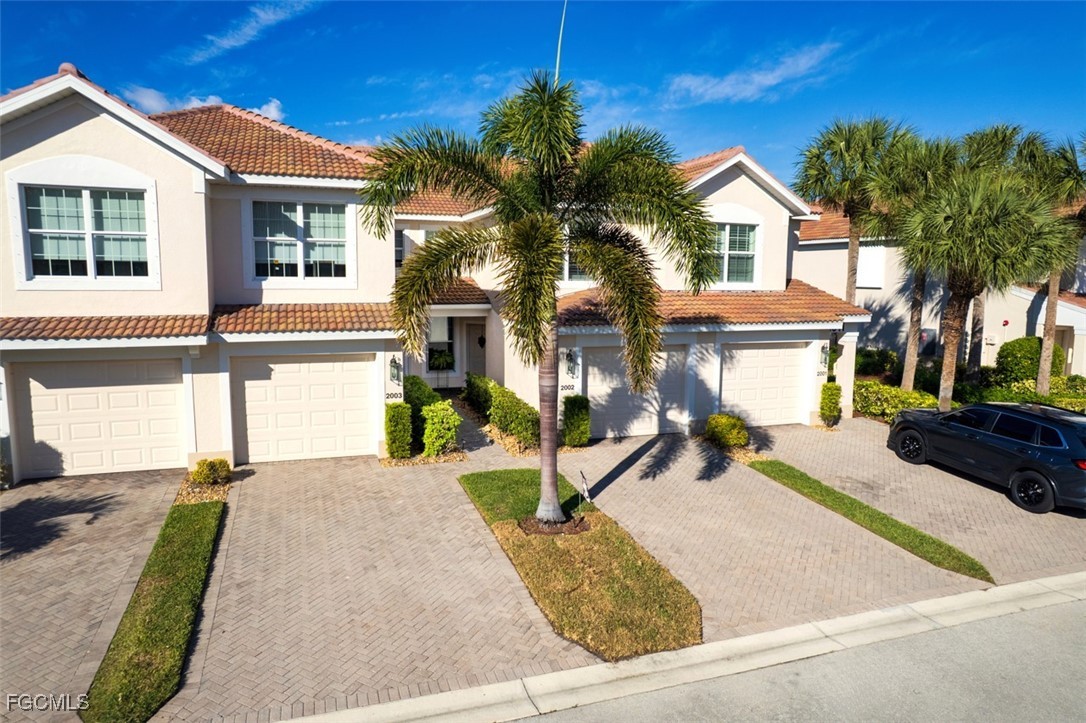 11611 Navarro Way, Unit 2002 Fort Myers, FL 33908 - Photo 37 of 45 a view of a house with a yard