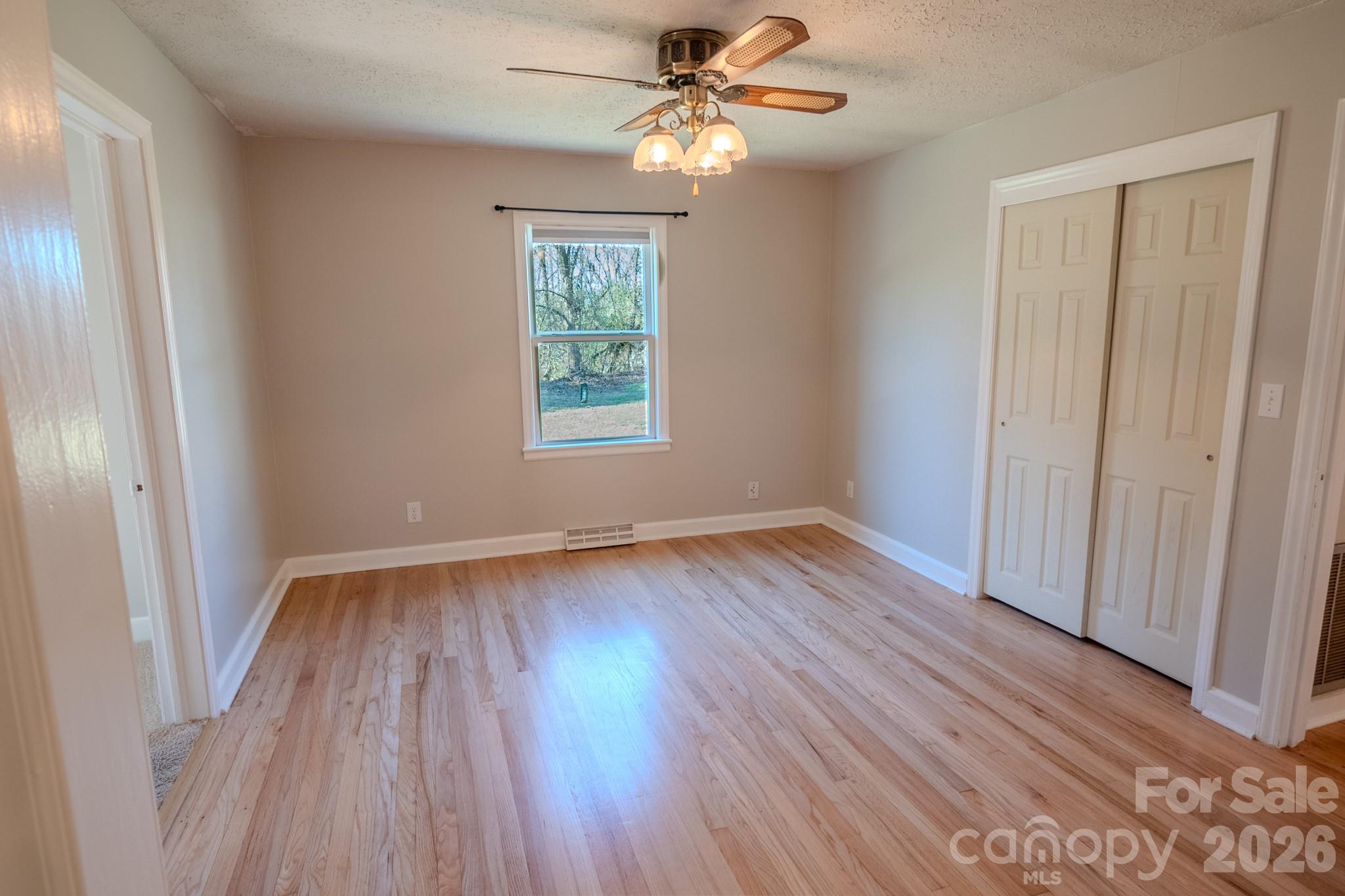 2113 Randolph Road Shelby, NC 28150 - Photo 14 of 39 wooden floor in an empty room with a window