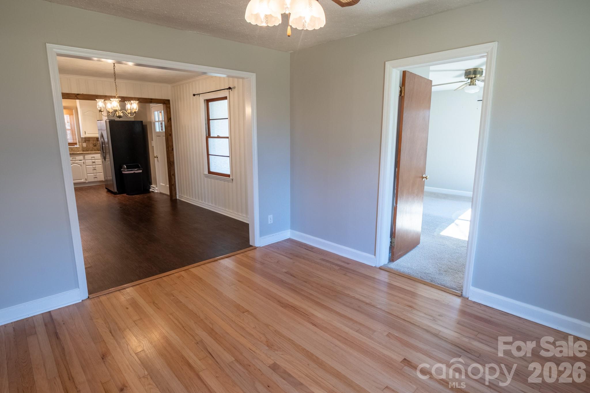 2113 Randolph Road Shelby, NC 28150 - Photo 15 of 39 a view of a hallway with wooden floor and a chandelier