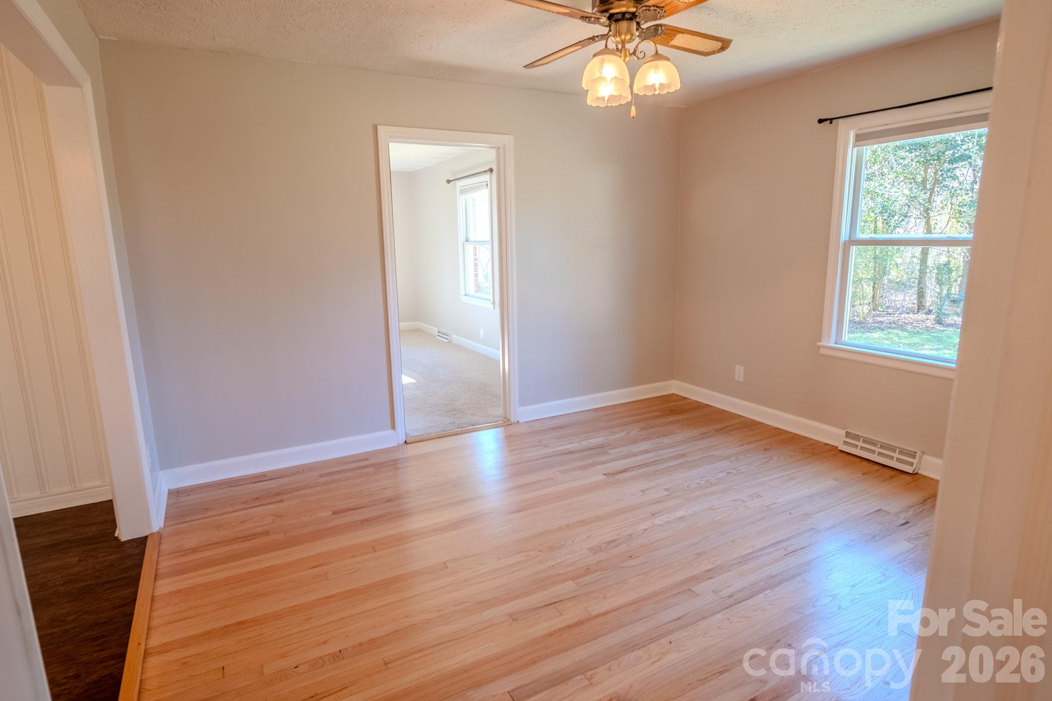 2113 Randolph Road Shelby, NC 28150 - Photo 16 of 39 a view of an empty room with wooden floor and a window