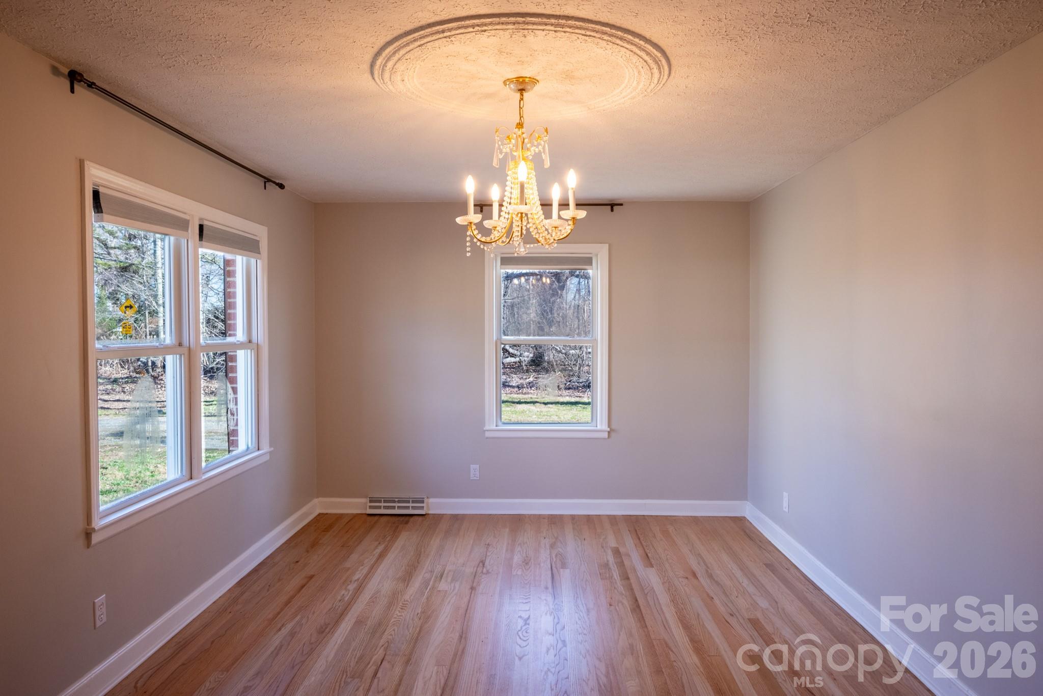 2113 Randolph Road Shelby, NC 28150 - Photo 2 of 39 a view of empty room with wooden floor and fan