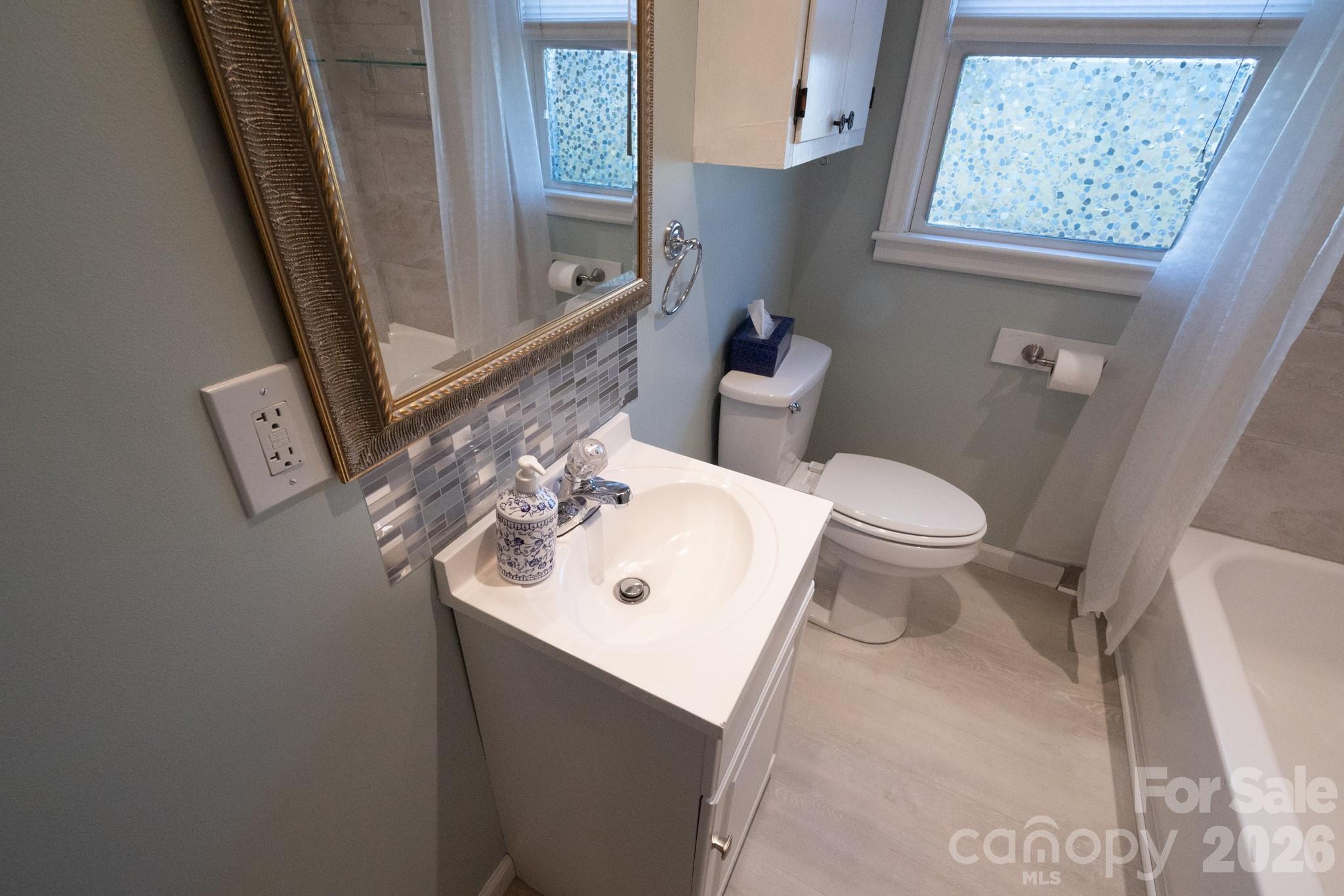 2113 Randolph Road Shelby, NC 28150 - Photo 22 of 39 a bathroom with a sink a toilet and a mirror