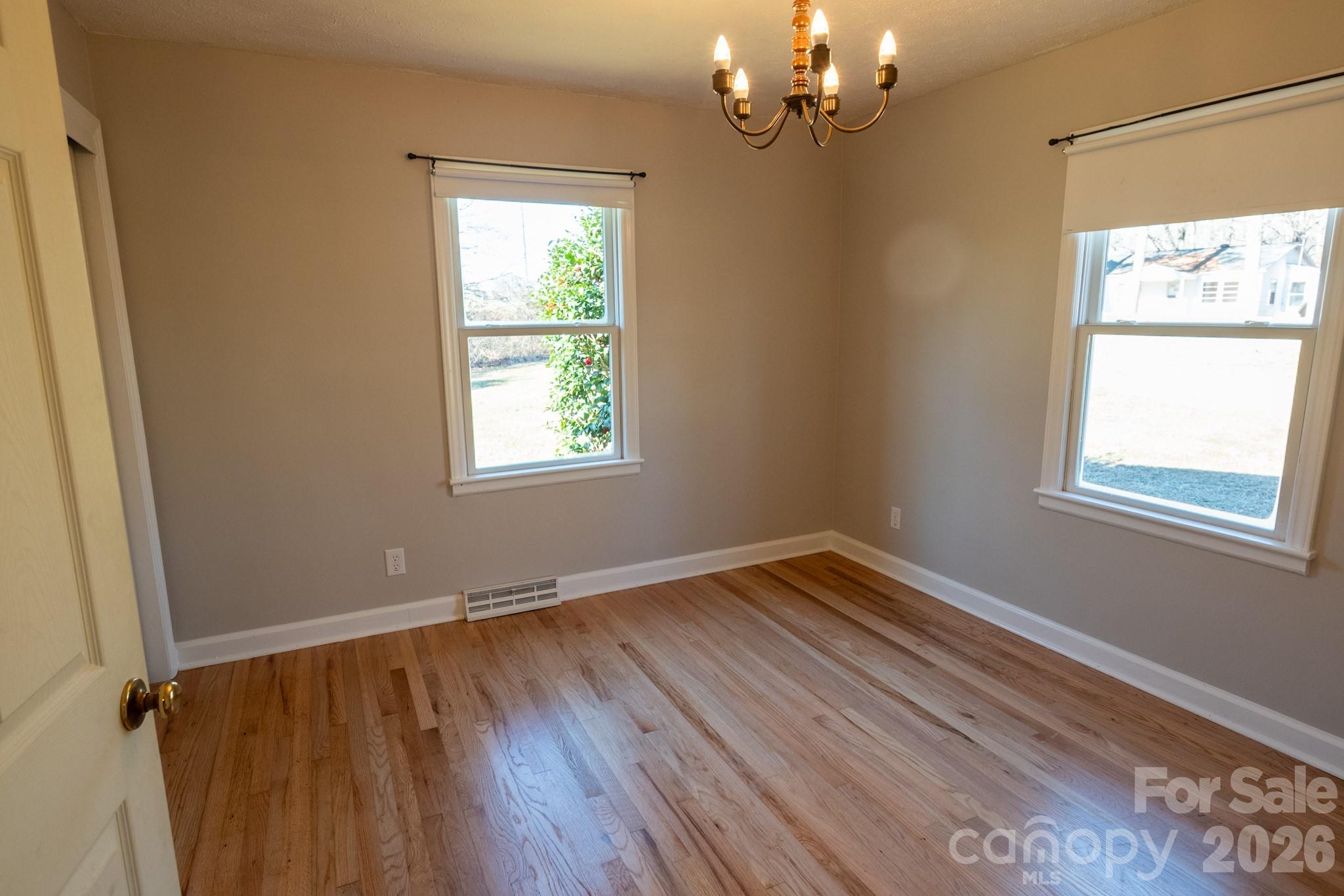 2113 Randolph Road Shelby, NC 28150 - Photo 25 of 39 a view of an empty room with wooden floor and a window