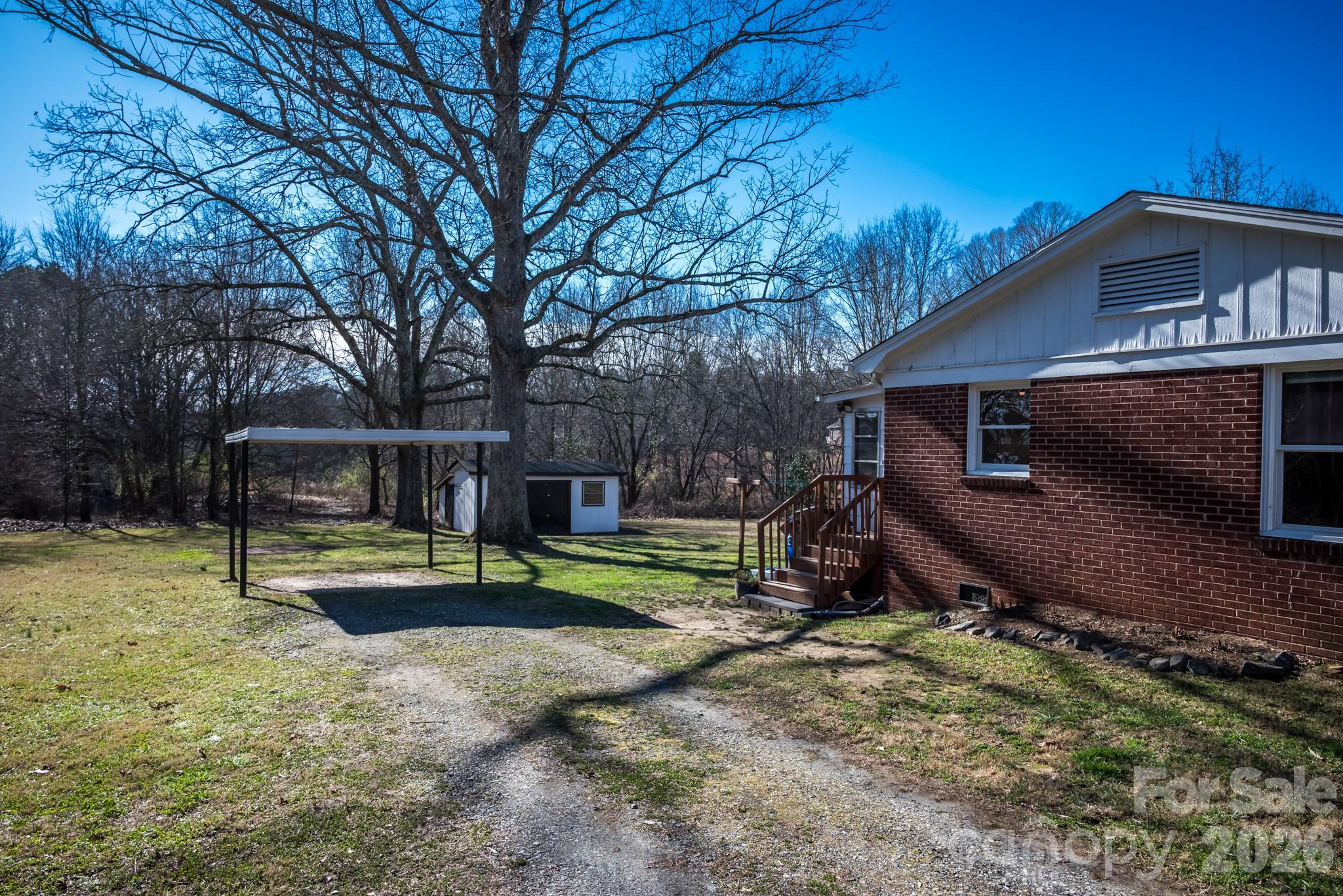 2113 Randolph Road Shelby, NC 28150 - Photo 29 of 39 a view of backyard with wooden fence and a large tree