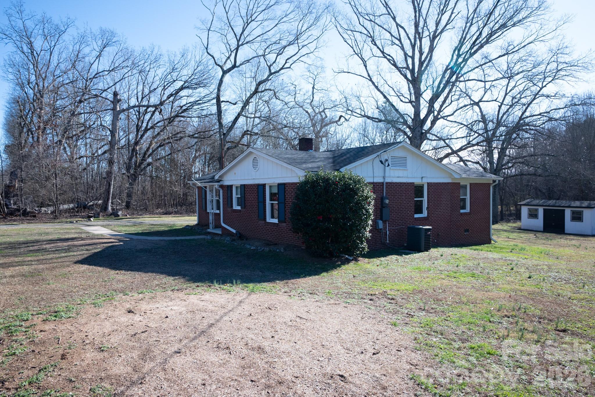 2113 Randolph Road Shelby, NC 28150 - Photo 36 of 39 a front view of a house with a yard covered with snow