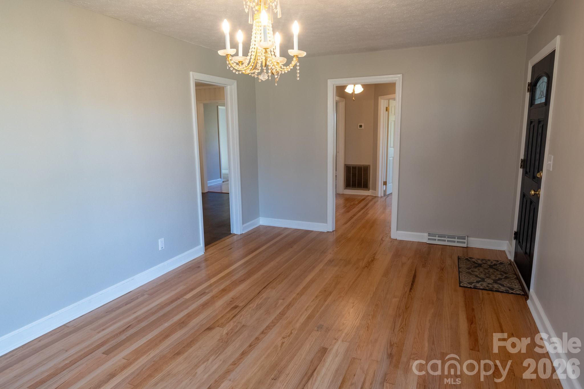 2113 Randolph Road Shelby, NC 28150 - Photo 4 of 39 wooden floor in an empty room with a window