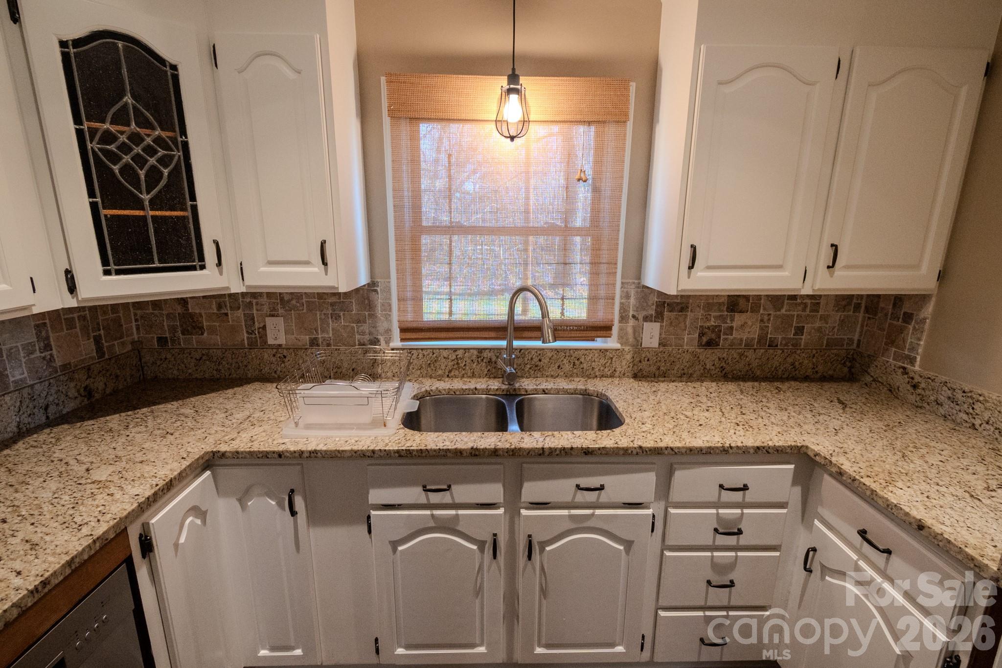 2113 Randolph Road Shelby, NC 28150 - Photo 7 of 39 a kitchen with granite countertop a sink a stove and cabinets