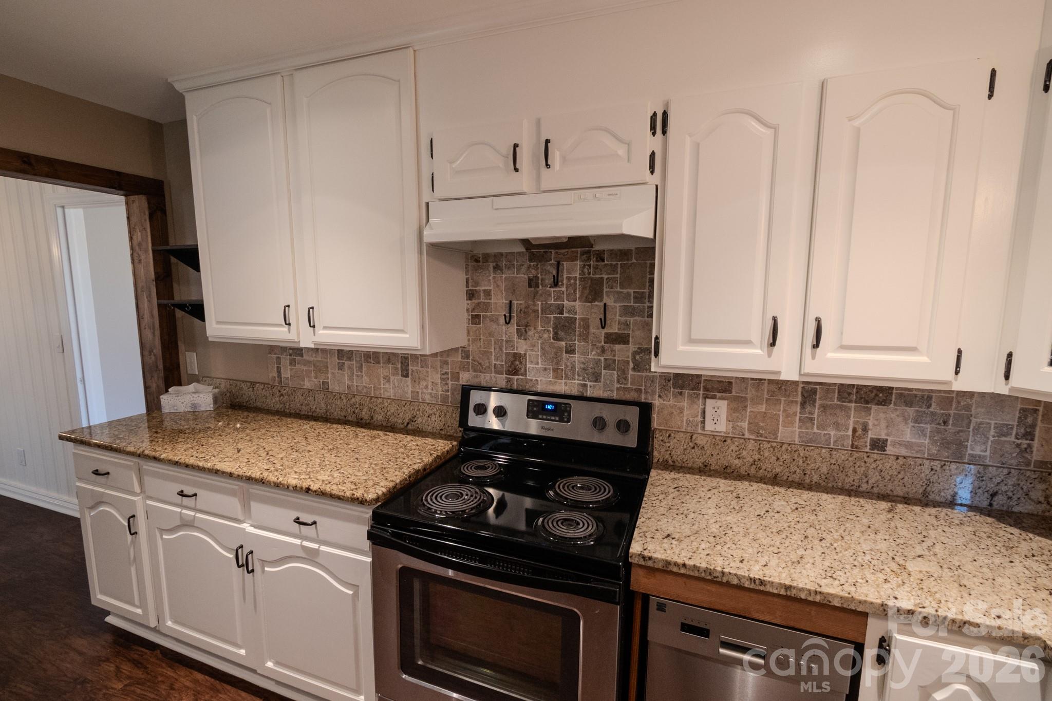 2113 Randolph Road Shelby, NC 28150 - Photo 8 of 39 a kitchen with granite countertop a stove sink and cabinets