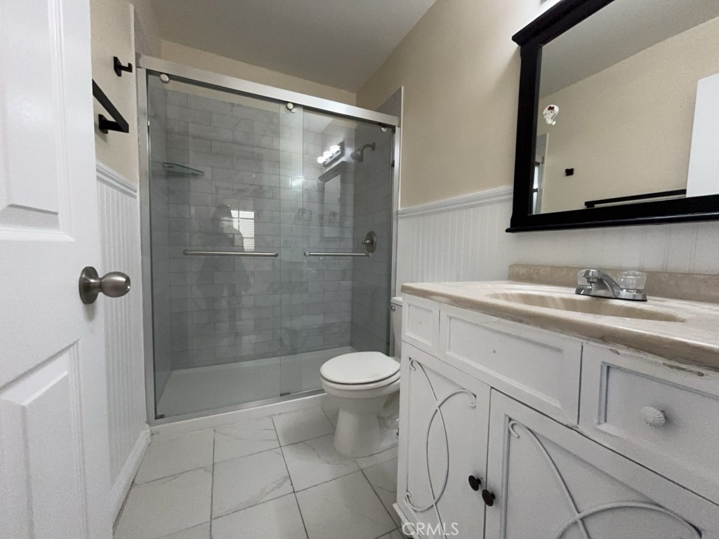 9263 Owari Lane Riverside, CA 92508 - Photo 12 of 17 a bathroom with a granite countertop sink toilet and shower