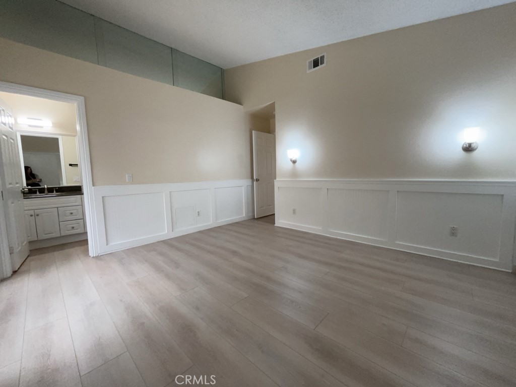 9263 Owari Lane Riverside, CA 92508 - Photo 14 of 17 an empty room with wooden floor and windows