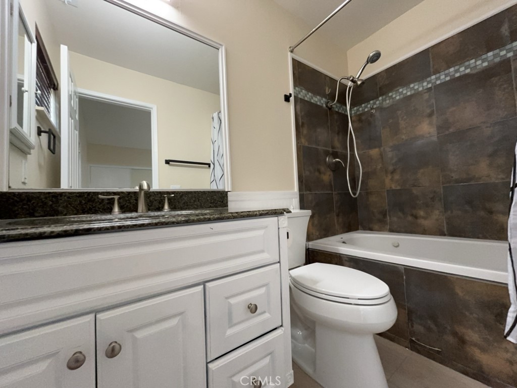9263 Owari Lane Riverside, CA 92508 - Photo 16 of 17 a bathroom with a sink a toilet and a bathtub