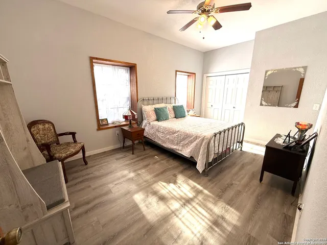 a bedroom with two beds and a chair