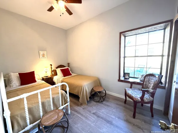 a bedroom with furniture and a window